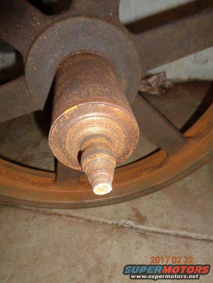 Rusted wheel hub and spindle with visible date stamp