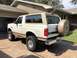 1995 Ford Bronco - This 1995 Ford Bronco is shown from the rear, its iconic spare tire cover and two-tone paint scheme.