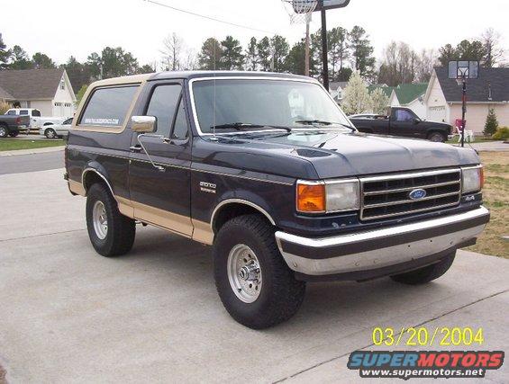 Dark blue and tan 1991 Ford Bronco, 3/4 front view