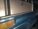 1979 Ford Bronco - Close-up of a teal fender and amber turn signal on a vehicle.