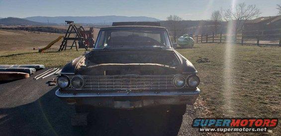 1962 Ford Galaxie front view, hood open, parked in a yard with a playground