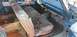 1962 Ford Galaxie - The interior of a 1962 Ford Galaxie shows significant wear and tear on the seats and rust on the floor.
