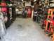 1992 Jeep Wrangler - A cluttered garage scene with storage, tools, and a red refrigerator.
