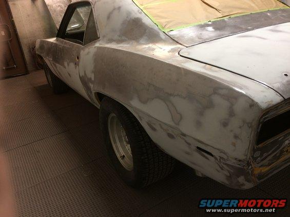 1969 Chevrolet Camaro bodywork in progress, showing primer and masking tape on the rear deck