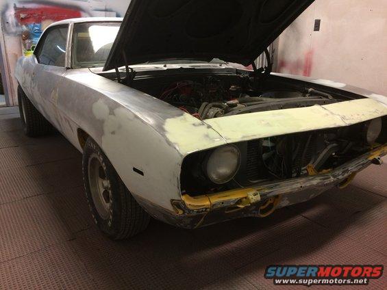 1969 Chevrolet Camaro bodywork in progress, hood open, showing engine bay