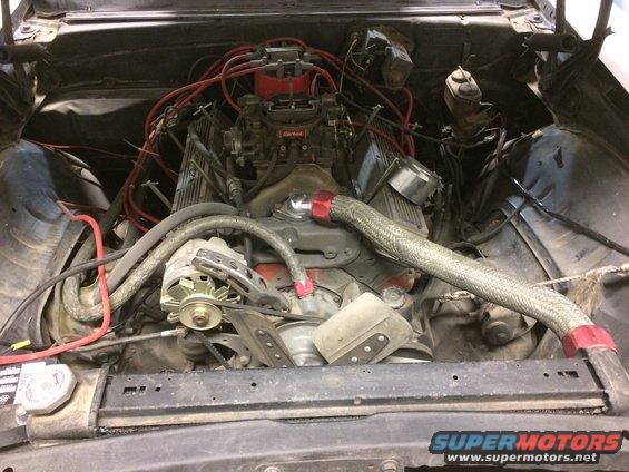 1969 Chevrolet Camaro engine bay with V8 engine, Edelbrock carburetor, and braided hoses