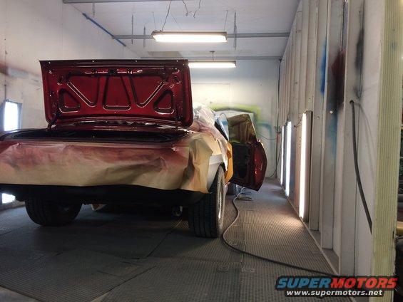 1969 Chevrolet Camaro in a paint booth with trunk open, being prepped for paint