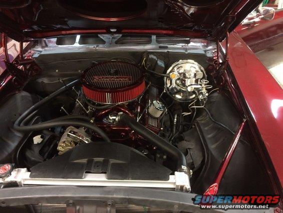 Red 1969 Chevrolet Camaro engine bay with chrome air cleaner and brake booster