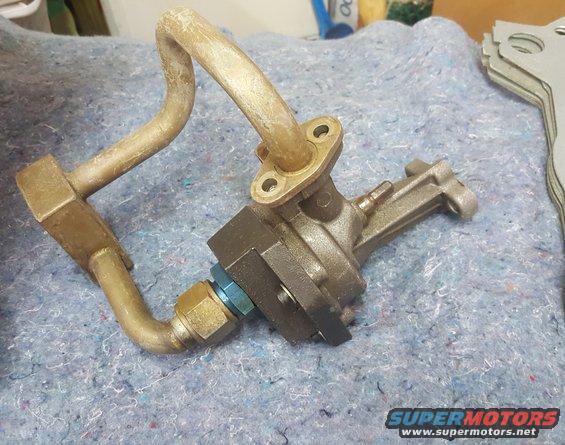 oil pump assembly with bent metal tubes and blue fitting