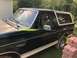 1993 Ford Bronco - This 1993 Ford Bronco is seen from the side, its dark green paint and white removable top.