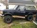 1995 Ford Bronco - This Ford Bronco has a two-tone paint scheme with a dark blue body and tan accents.