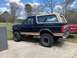 1995 Ford Bronco - This 1995 Ford Bronco is seen from the side, its distinctive two-tone paint and removable top.