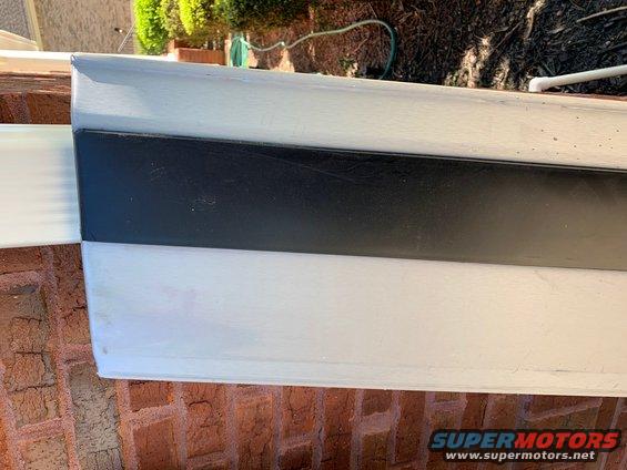 Black trim on white body panel with Supermotors logo