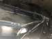 1995 Ford Bronco - Close-up view of a vehicle's transmission pan, showing bolts and some surface wear.