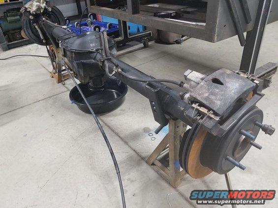 20190424_190501.jpg A lot has changed, and a lot of money has been spent, but not on anything that shows...

To put this in my '83 Bronco, I had to regear it.  I didn't want to spend the money on new Ford gears (~$350), and I certainly didn't want aftermarket gears, so I took a chance on a take-out set of Ford 3.08s (~$150 eBay), which of course required an install kit (~$40 RockAuto), new axle seals (~$15 RockAuto [url=https://www.amazon.com/dp/B0012UK41W]National/Timken 8835S[/url]), and a new pinion shaft lock bolt (~$5 Ford).  When I pulled the axles, I noticed a serious groove in the RH axle due to bearing wear.  Ford wants ~$250 for a new shaft, so I took another chance on a Dorman ($130 O'Reilly, made in India) which included a bearing (apparently made in USA by KOYO), a seal (no ID), lugs & nuts (no ID).  But I bought a MotorCraft bearing (~$30 eBay), and reused the original lug studs.  I paid a friend with a LOT of gear experience $150 to set up the gears, and I reassembled the axle.  The original oil was clean, and what little metal was in it settled out, so I poured it back in & E6000'ed the sandblasted & painted cover back on.  I'm tilting it back & forth to put oil into the wheel bearings before installation.  I'll figure out the e-brake cables after the axle is in the truck (which is why I'm doing it to my DD first).

Ford 8.8&quot; axle uses 10 lug studs [url=https://www.tascaparts.com/oem-parts/ford-wheel-stud-d6az1107a]D6AZ-1107-A[/url] ('83-00)
Dana 44IFS uses 10 lug studs D6TZ-1107-A ('83-96)
Ford TIB axle uses 10 lug studs F4UZ-1107-A ('94-96)

If I do this swap to the '93EB I'm building, I won't have to regear it (3.55 already).  And if I find one with good bearings, I won't have to spend all that money again, either.

I pressure-washed & reused the [url=https://www.amazon.com/dp/B000NTVLL0]pads (4C2Z-2001-BB)[/url] & [url=https://www.tascaparts.com/oem-parts/ford-brake-shoes-4c2z2648aa]e-brake shoes (4C2Z-2001-BB)[/url]

I haven't decided yet whether to replace or reuse the U-bolts...