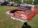 1960 Ford Starliner - Rear view of a weathered 1960 Ford Starliner, showing its iconic tail fins and chrome bumper.