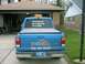 1999 Ford Crown Victoria - A blue Ford pickup truck is parked in a driveway, displaying company information on its tailgate.