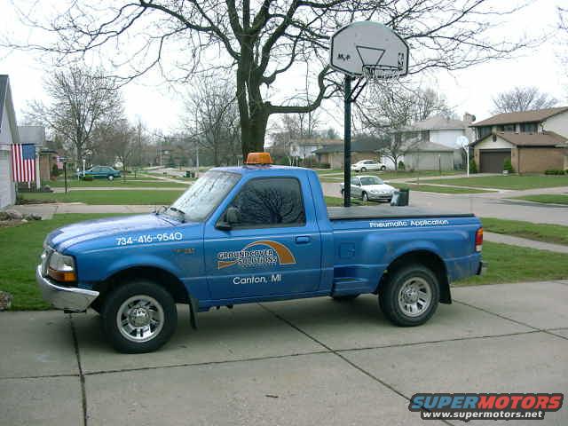 Blue Ford pickup truck with "GROUNDCOVER SOLUTIONS" logo and phone number 734-416-9540 on the door