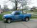 1999 Ford Crown Victoria - Blue Ford pickup truck parked on a driveway with a basketball hoop in the background.