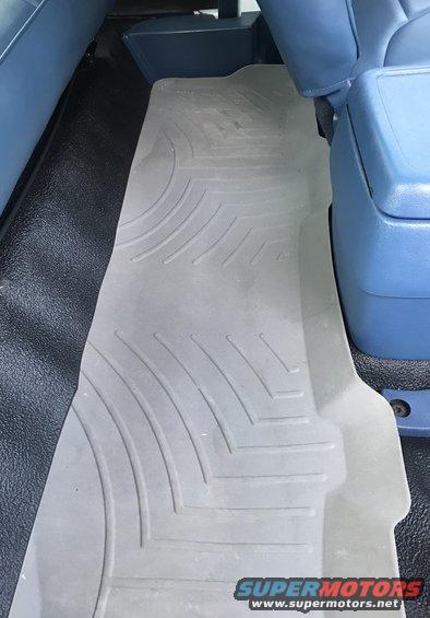 Gray WeatherTech floor mats in a vehicle's interior, covering the floor behind the front seats
