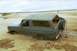 1979 Ford Bronco - A gray 1978 Ford Bronco is partially buried in sand, with a person attempting to free it.