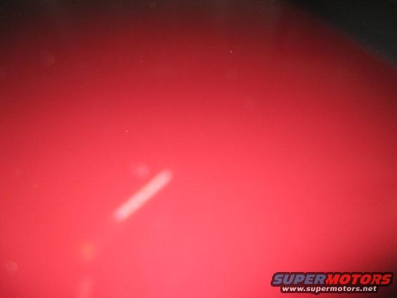 Red car hood with a diagonal reflection