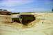 1979 Ford Bronco - This vehicle appears to be stuck in the sand with its door open, while another vehicle waits nearby.