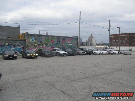 Front view of a 2004 Ford Crown Victoria parked in a line with other sedans