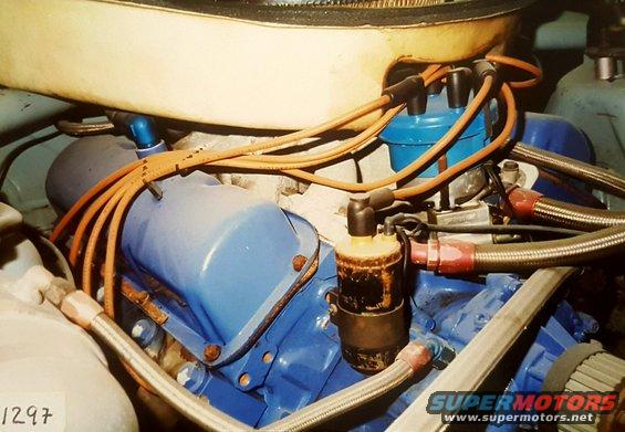 Close-up of engine components including spark plug wires, distributor cap, and ignition coil