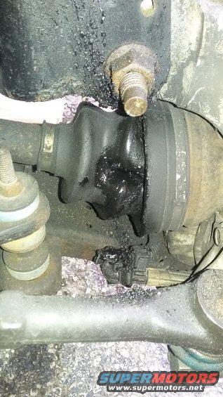 Torn CV boot with grease splatter