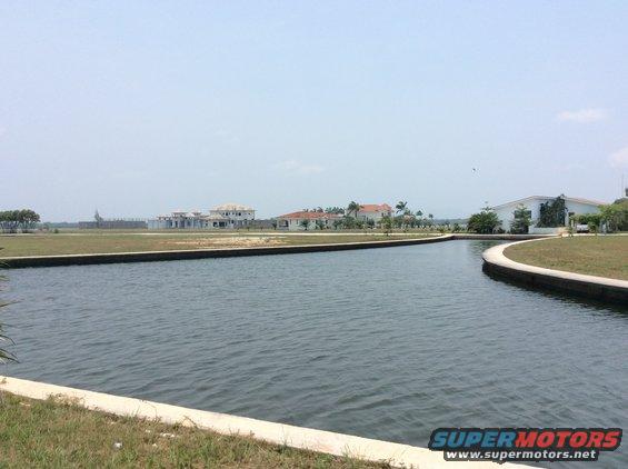 Waterway with houses and a fence in the background