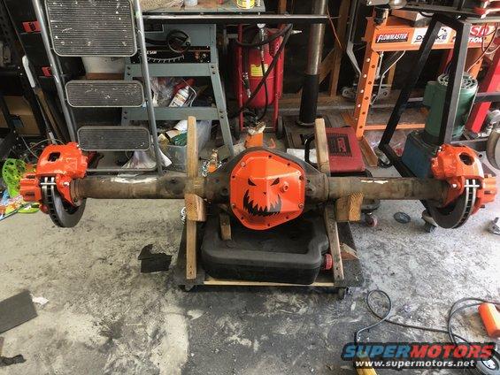 Differential housing with jack-o'-lantern cover and orange brake calipers