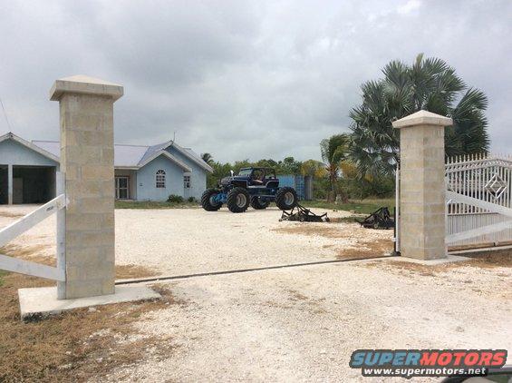 Monster truck with large tires parked in front of a house