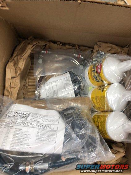 Box of automotive parts including Red Line MT-90 oil and Advance Adapters transfer case cable