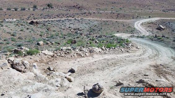Dirt road winding through a rocky, arid landscape