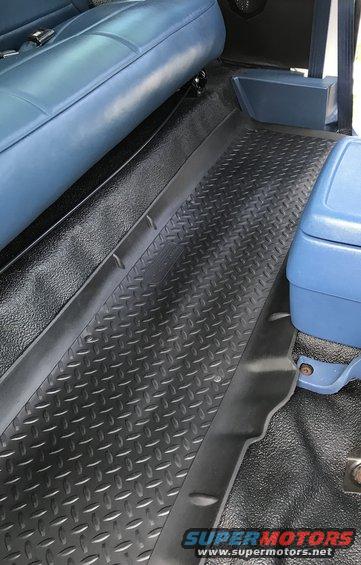 Diamond plate flooring and blue vinyl seats inside a vehicle