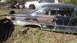 1961 Ford Starliner - This weathered car sits in a junkyard, showing significant rust and damage, with another vehicle visible in the background.