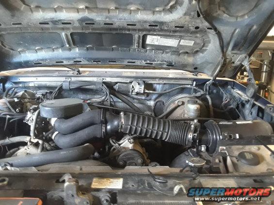 1996 Ford F-350 engine bay with air intake and hoses visible
