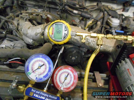 engine bay with AC gauges connected to engine components