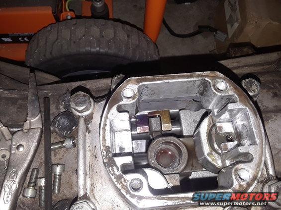 Close-up of internal transmission shifter mechanism with tools nearby
