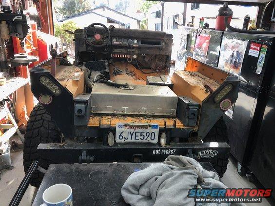 1992 Jeep Wrangler interior and rear view, showing dashboard, seats removed, and aftermarket bumper with license plate