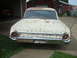 1962 Ford Galaxie - This old Ford sedan is parked outside a red barn, showing significant wear and tear.