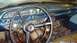 1962 Ford Galaxie - The dashboard and interior of an older vehicle, showing the steering wheel, gauges, and radio.