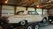 1962 Ford Galaxie - This weathered 1961 Ford Galaxie is loaded onto a trailer, revealing its aged condition and distinctive body style.