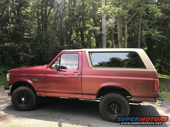 Red and tan 1994 Ford Bronco, side view