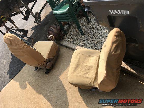 Two tan car seats with covers, one with visible stitching
