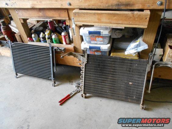 Two car radiators or AC condensers on a concrete floor, one on the left and one on the right, with red-handled pliers between them