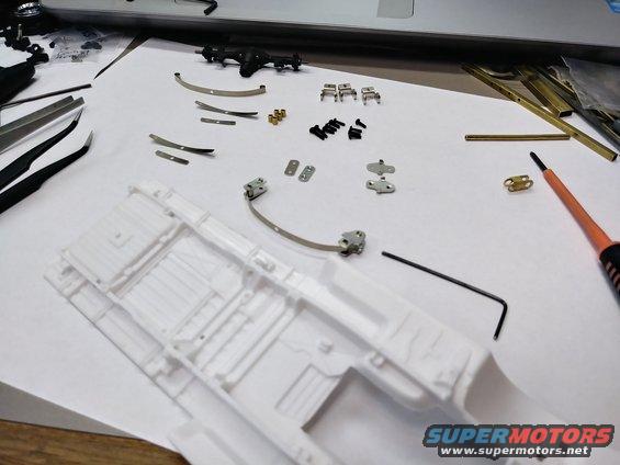Parts laid out with the axle and the chassis.