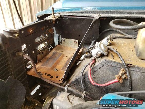 20190522_133715.jpg With the custom mounting plate between the fender & inner fender, this '87-96 F-series/Bronco battery tray fits surprisingly well.  And most of the battery's weight will be borne by the top of the inner fender, where it's strongest.  I didn't have to drill any new holes in the original metal, and nothing is welded.

I rearranged the battery cables to fit better, and also cleaned the starter relay terminals. Later, I might replace the battery cable terminals.