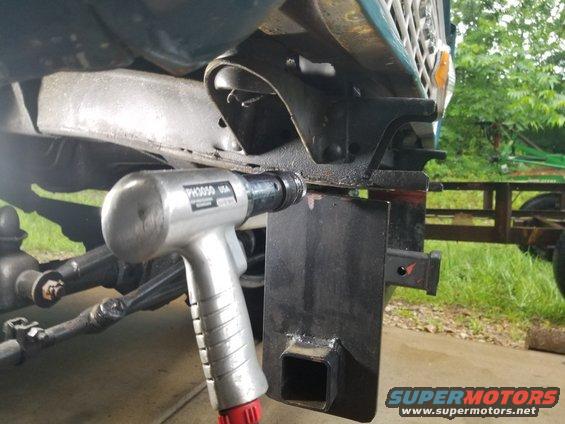 Eventually, I felt like I had weakened the welds enough, and they broke with a little encouragement.  I put some vise grips on this side, and went to work on the HARD side - where the steering box & track bar bracket are in the way.
